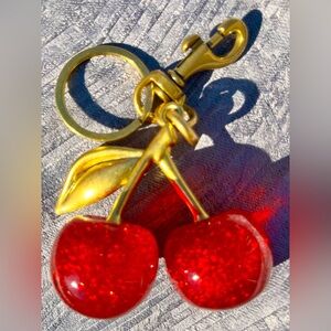 Cherries keychain bag charm. Coach like fashion, unbranded. New. Red and gold.